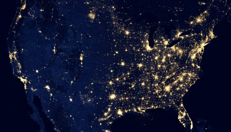 Shot of earth from space, at night, as city lights twinkle